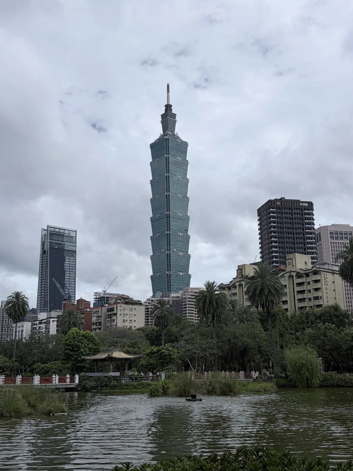 Taipei 101 above the park and water.